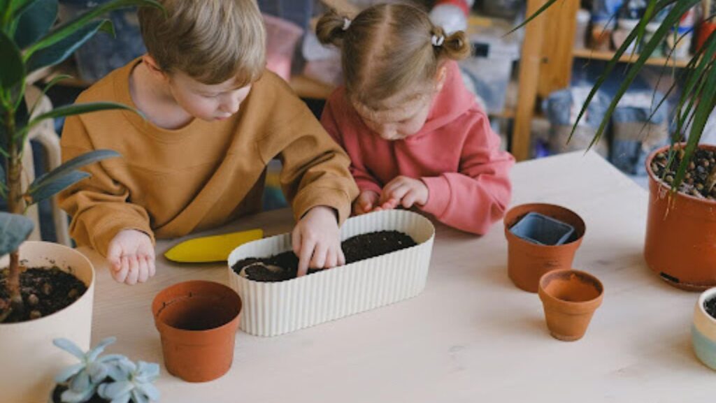 kids inspecting potted soil