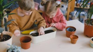 kids inspecting potted soil